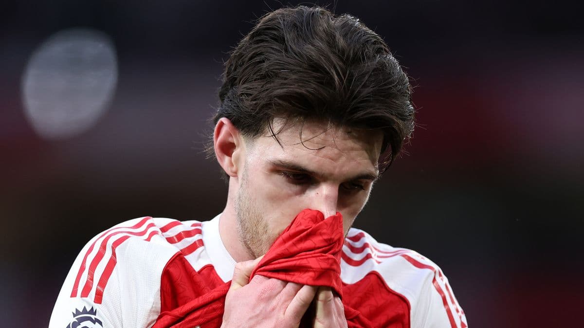 Player looking down while holding jersey close