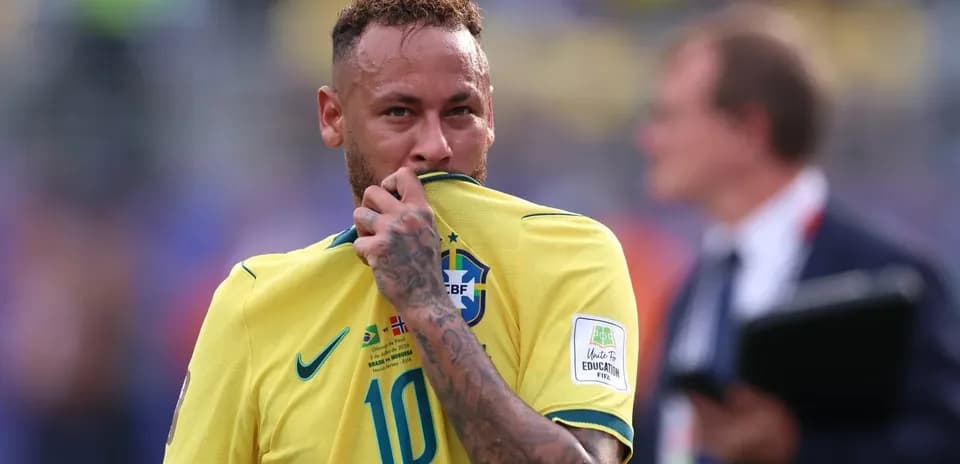 Neymar in Brazil jersey touching his shirt