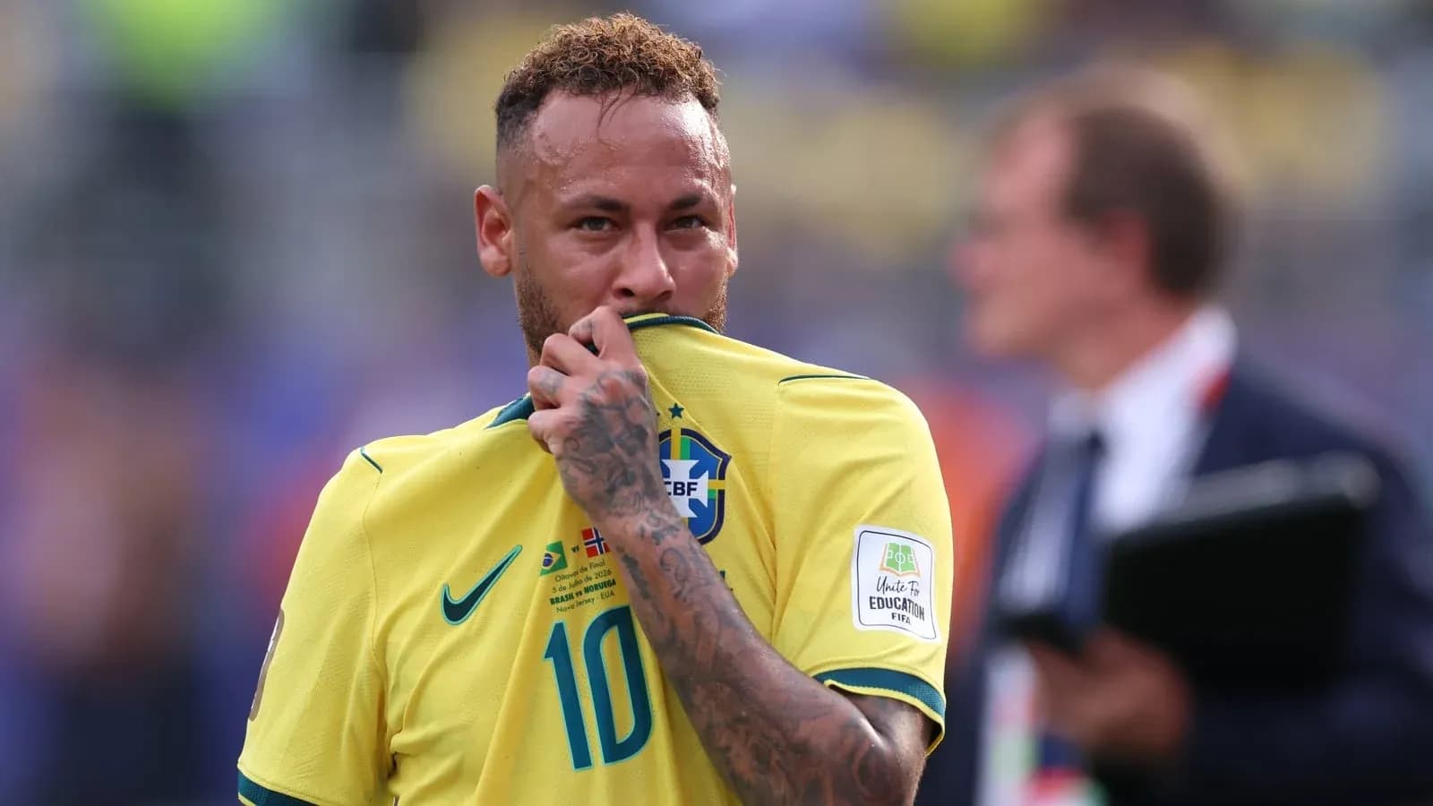 Neymar in Brazil jersey touching his shirt