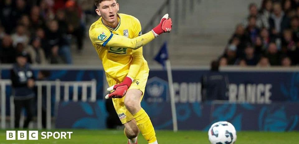 Goalkeeper in yellow kit making a throw during match