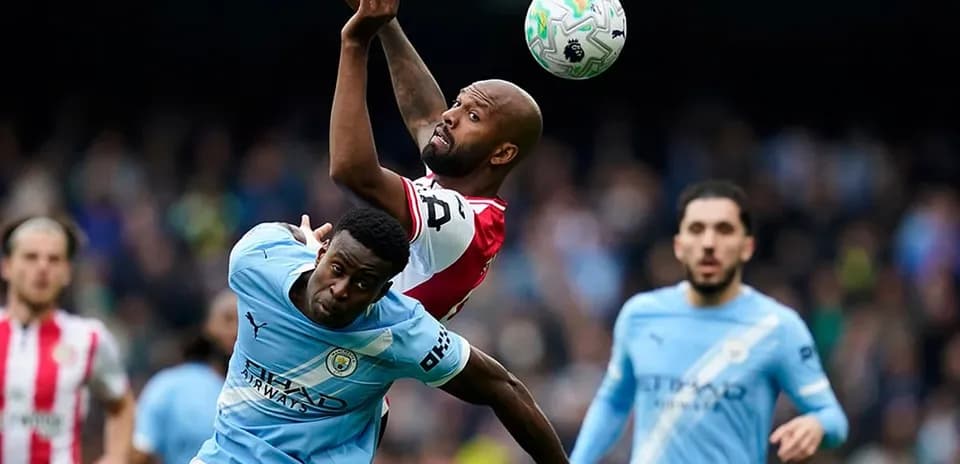 Manchester City player challenging Brentford opponent