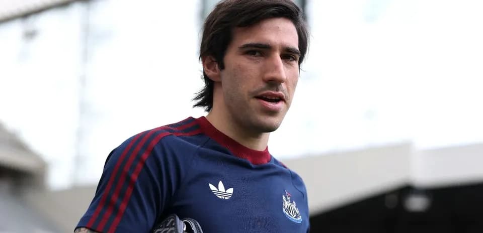 Football player wearing Newcastle training kit outdoors
