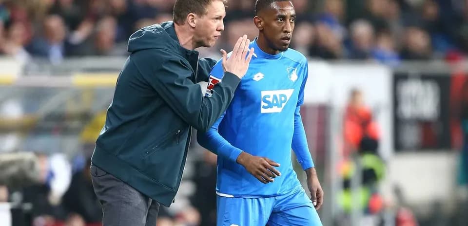Coach instructing player during match on sidelines