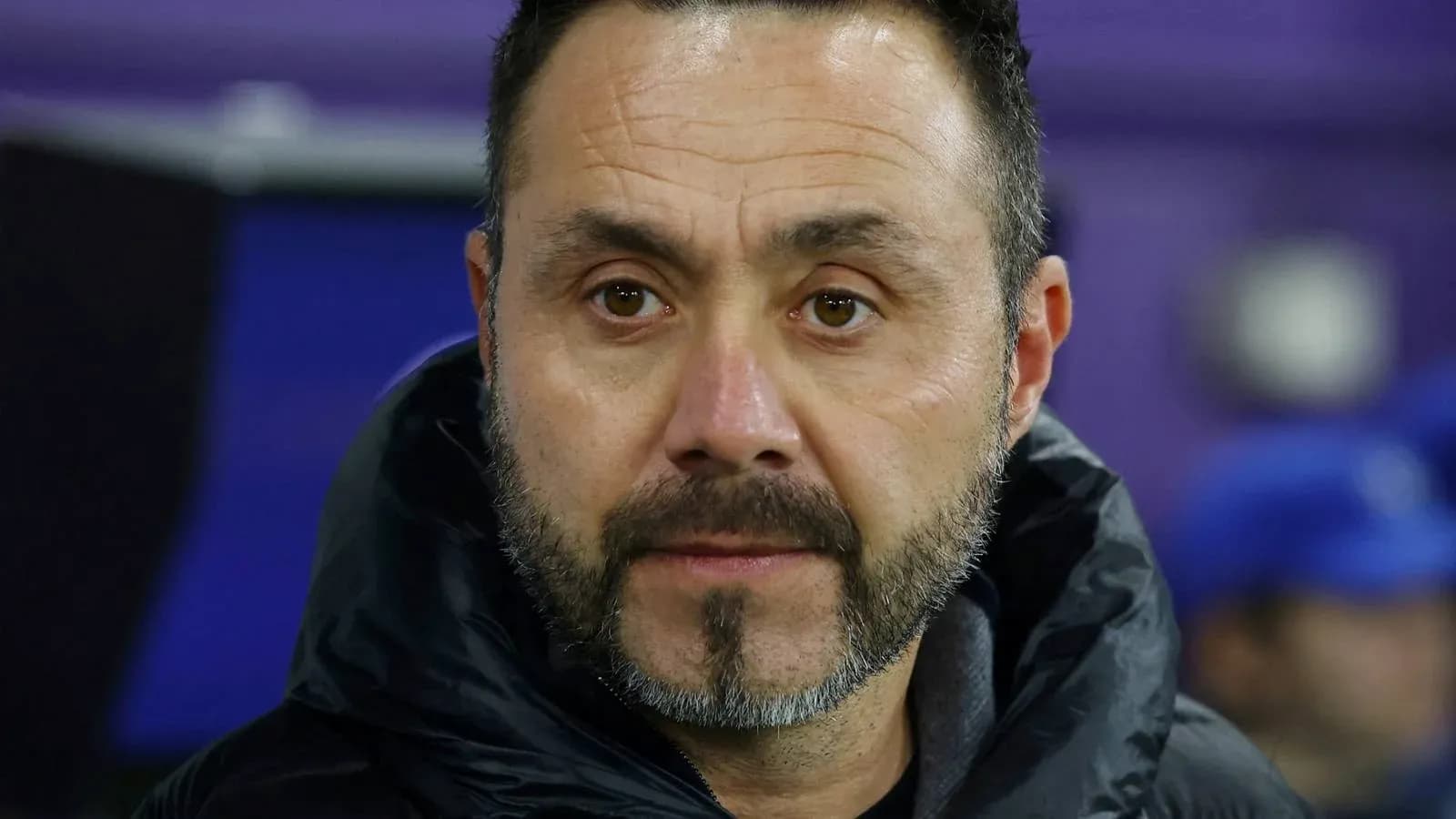 Coach observing from the sidelines during match