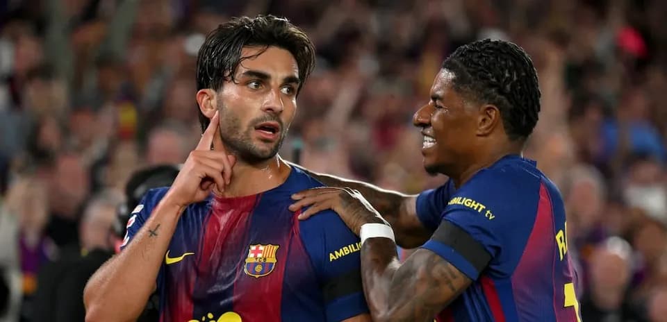 Two FC Barcelona players celebrating after a goal