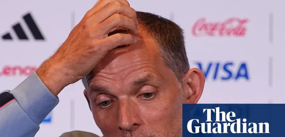 Manager speaking during press conference with hand on head
