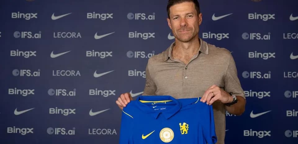 New coach holding Chelsea FC jersey at presentation