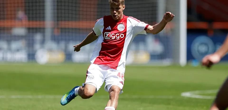 Ajax player kicking the ball on the field