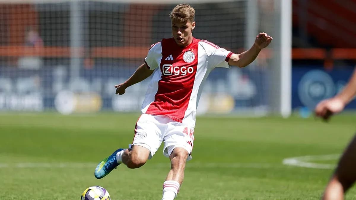 Ajax player kicking the ball on the field