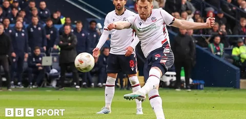 Bolton player striking the ball during match