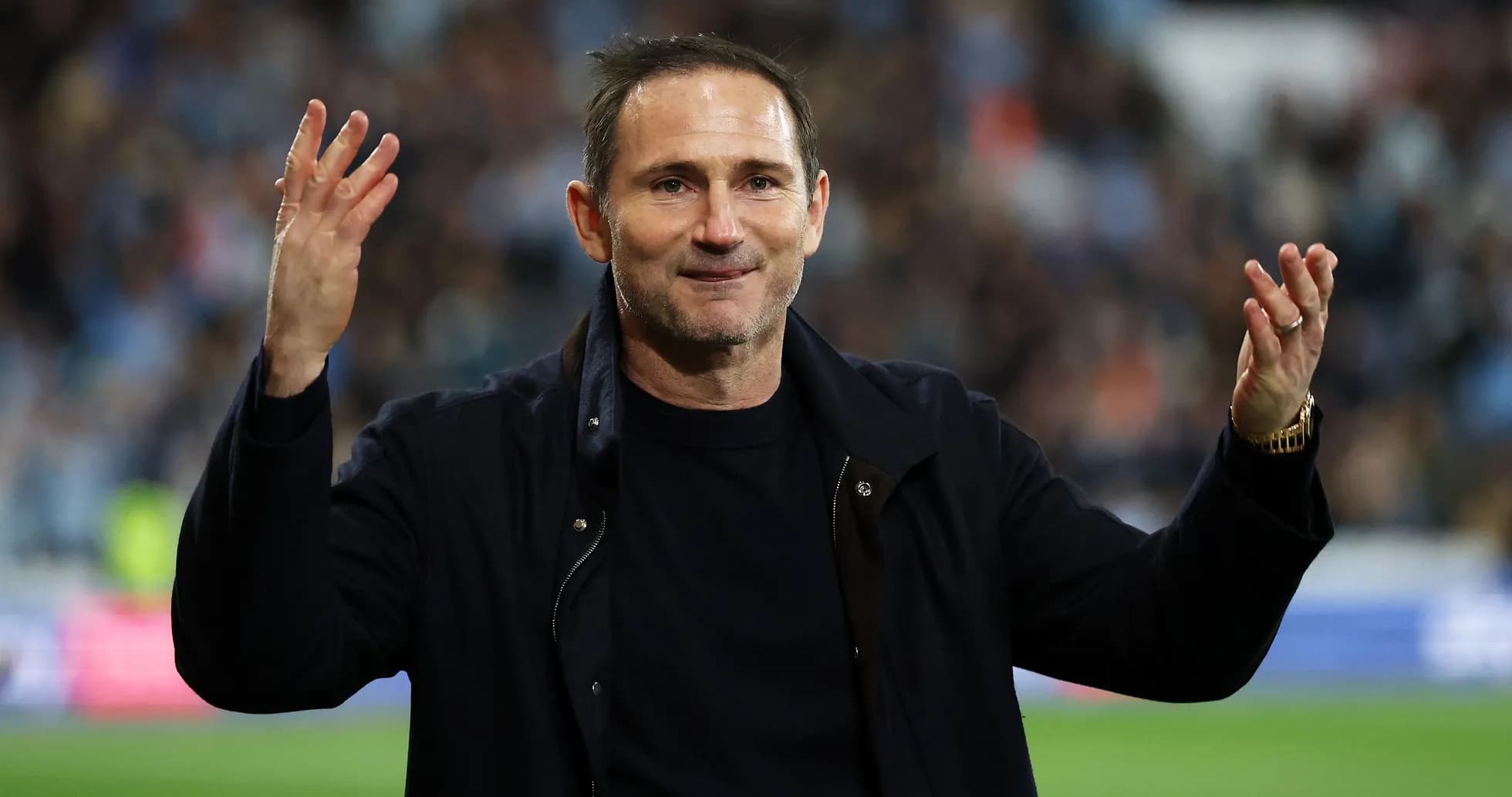 Coach gesturing to fans during a match