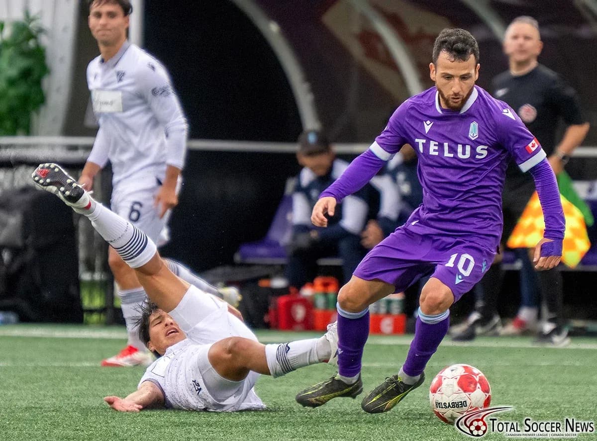 Player avoiding tackle during Vancouver FC match
