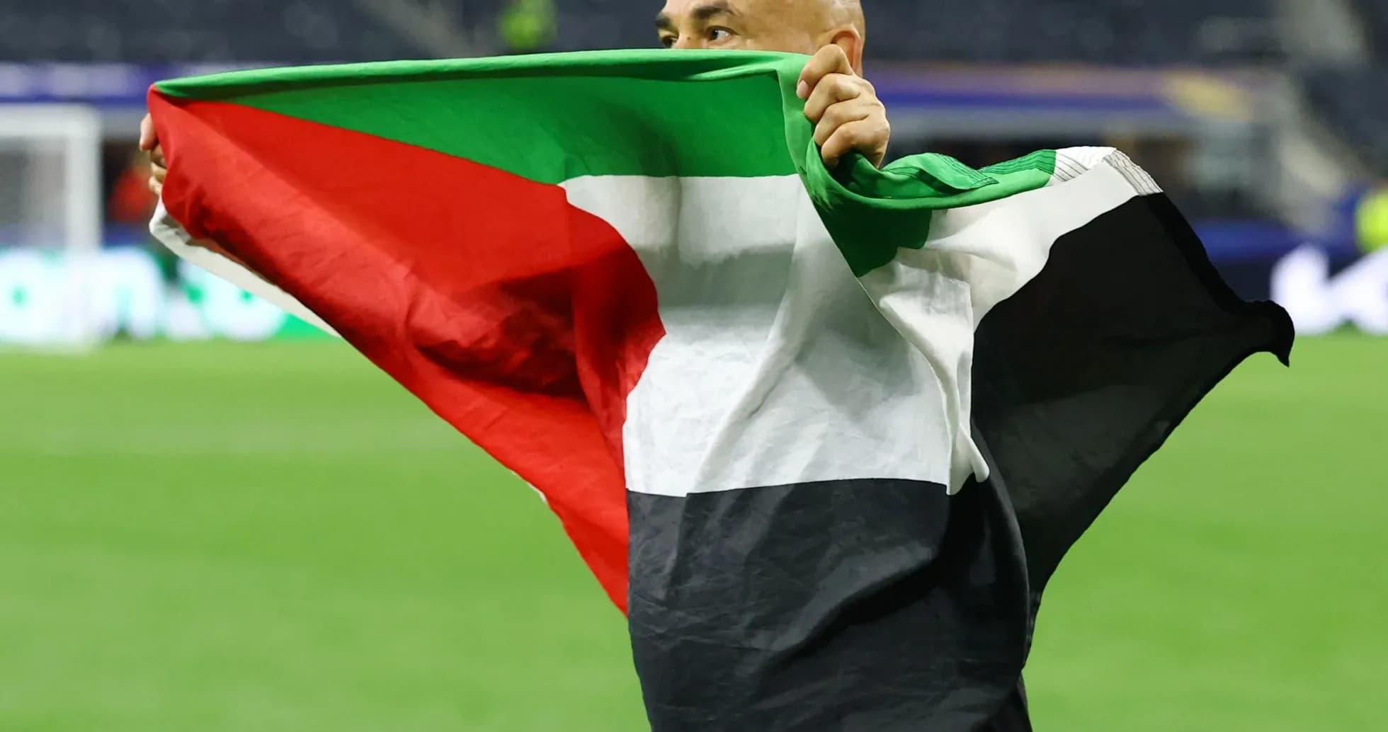 Person celebrating with a flag on the field