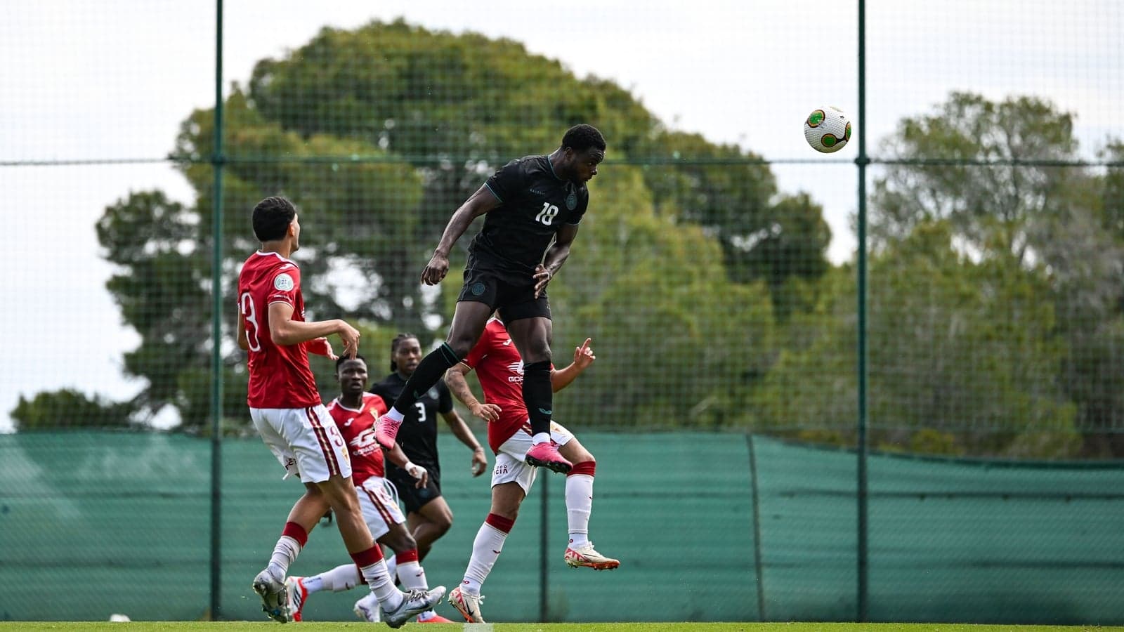 Player jumping to head the ball during training session