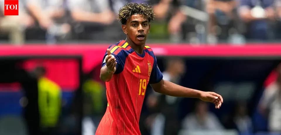 Player in red Spain jersey signaling during match