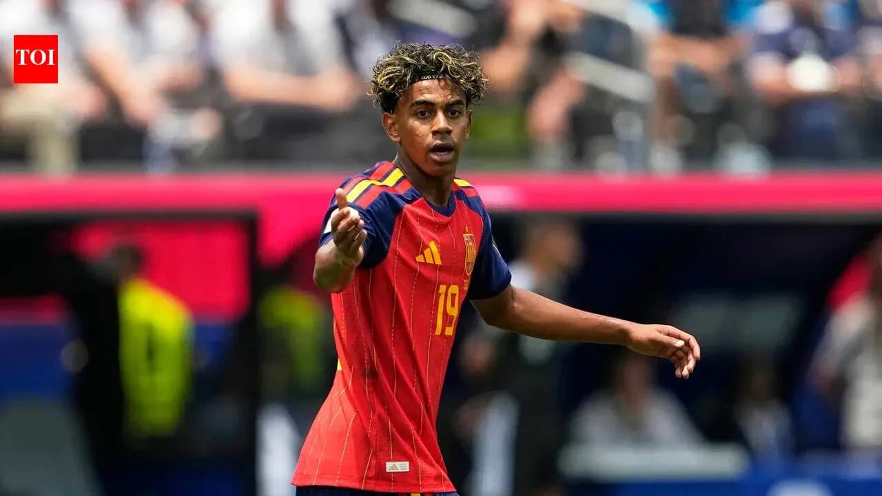 Player in red Spain jersey signaling during match