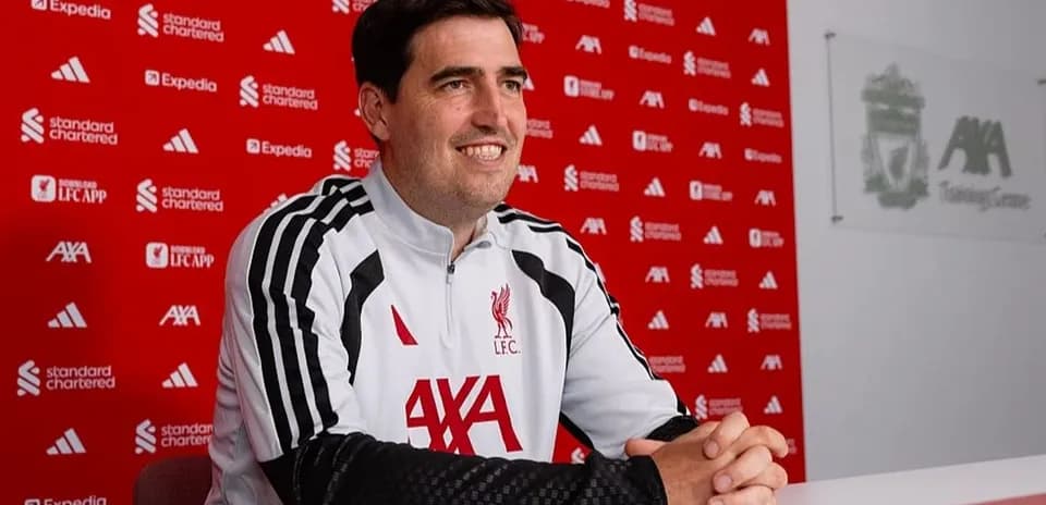 Manager seated at press conference table in training center