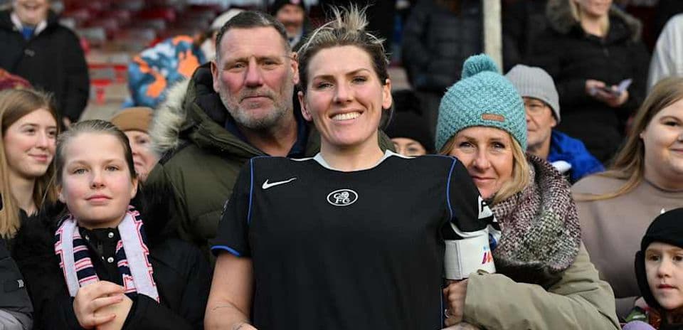 Player posing with fans at the stadium