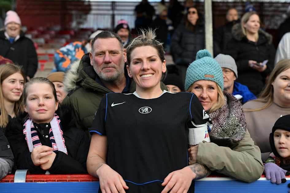 Player posing with fans at the stadium