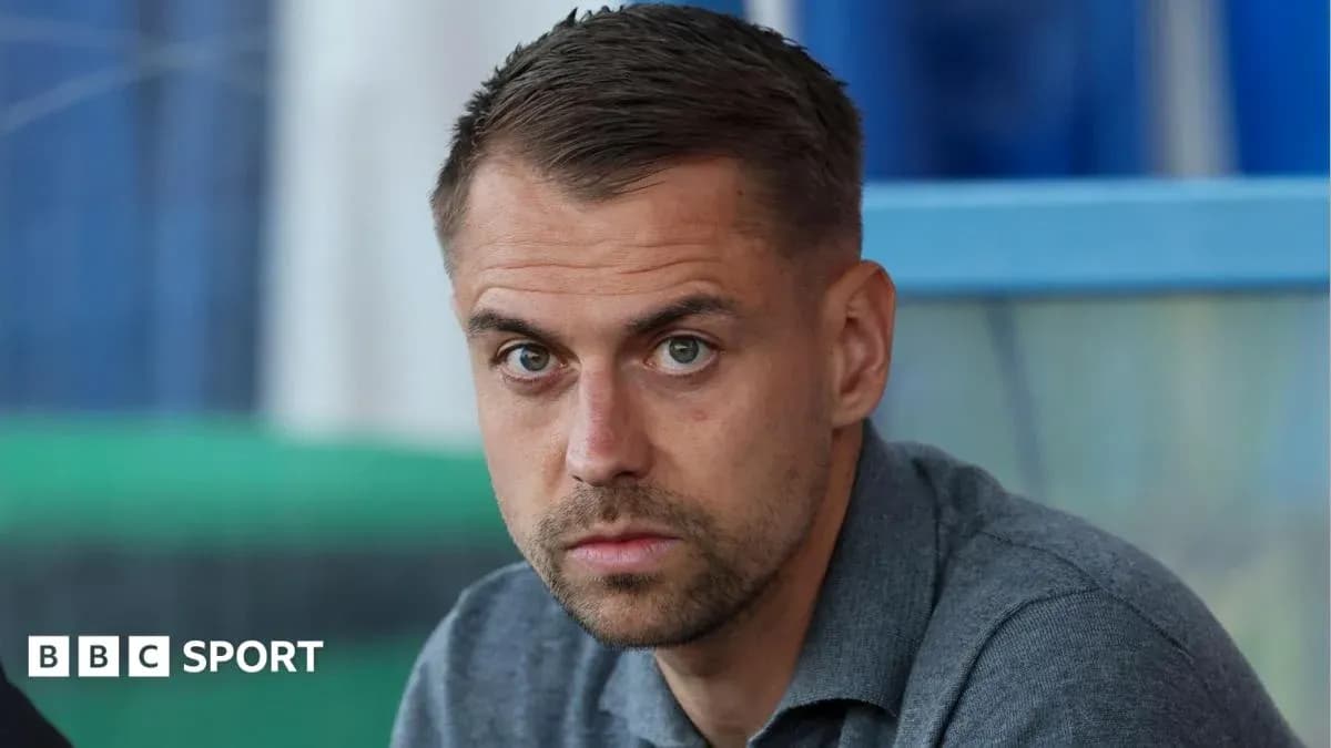 Man with short hair looking directly at camera