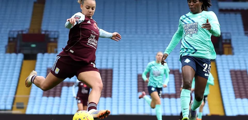 Aston Villa player kicking the ball during match