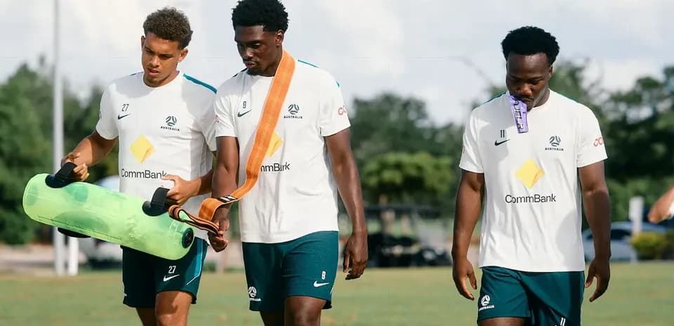 Three players walking during training session outdoors