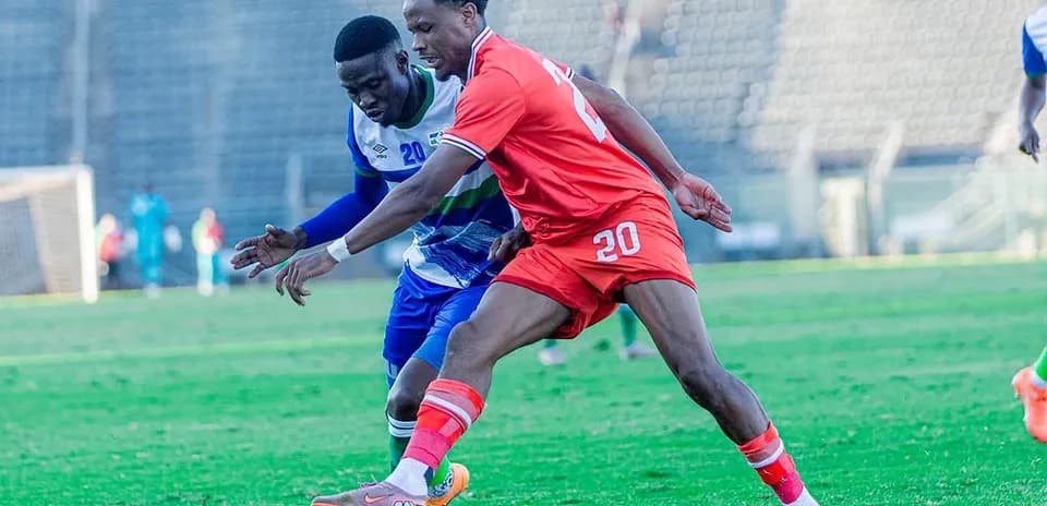 Two players competing for the ball in a match