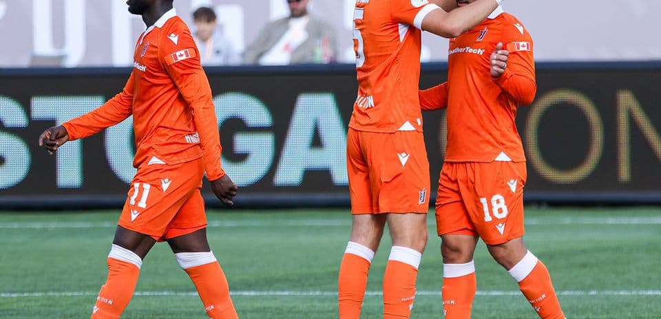 Players celebrating during Forge FC match