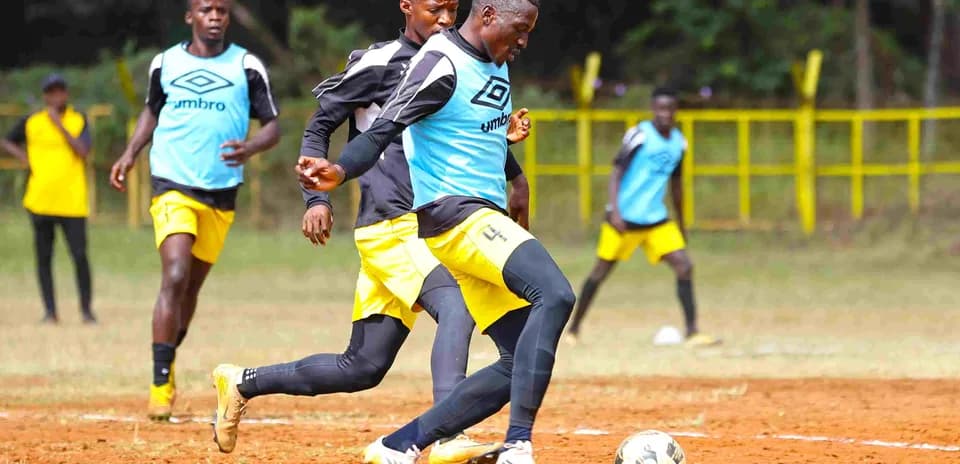 Players training on the field before the match