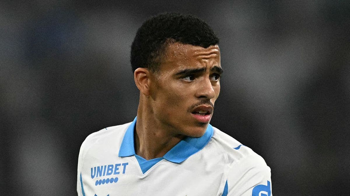 Player wearing Marseille jersey during match action