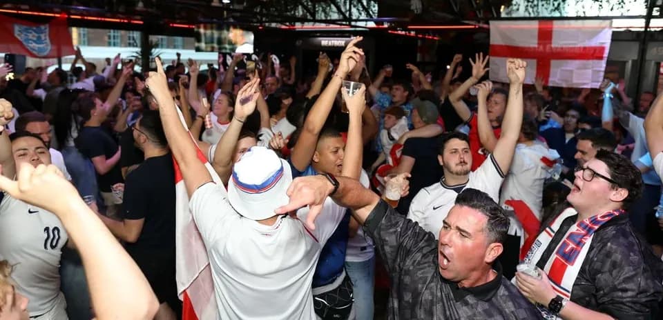 Crowd of fans celebrating in a bar