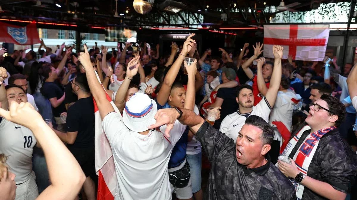 Crowd of fans celebrating in a bar