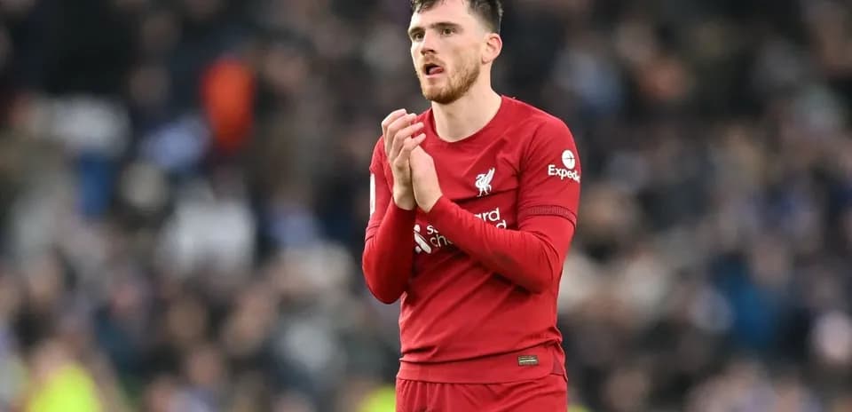 Player in red Liverpool kit clapping to fans