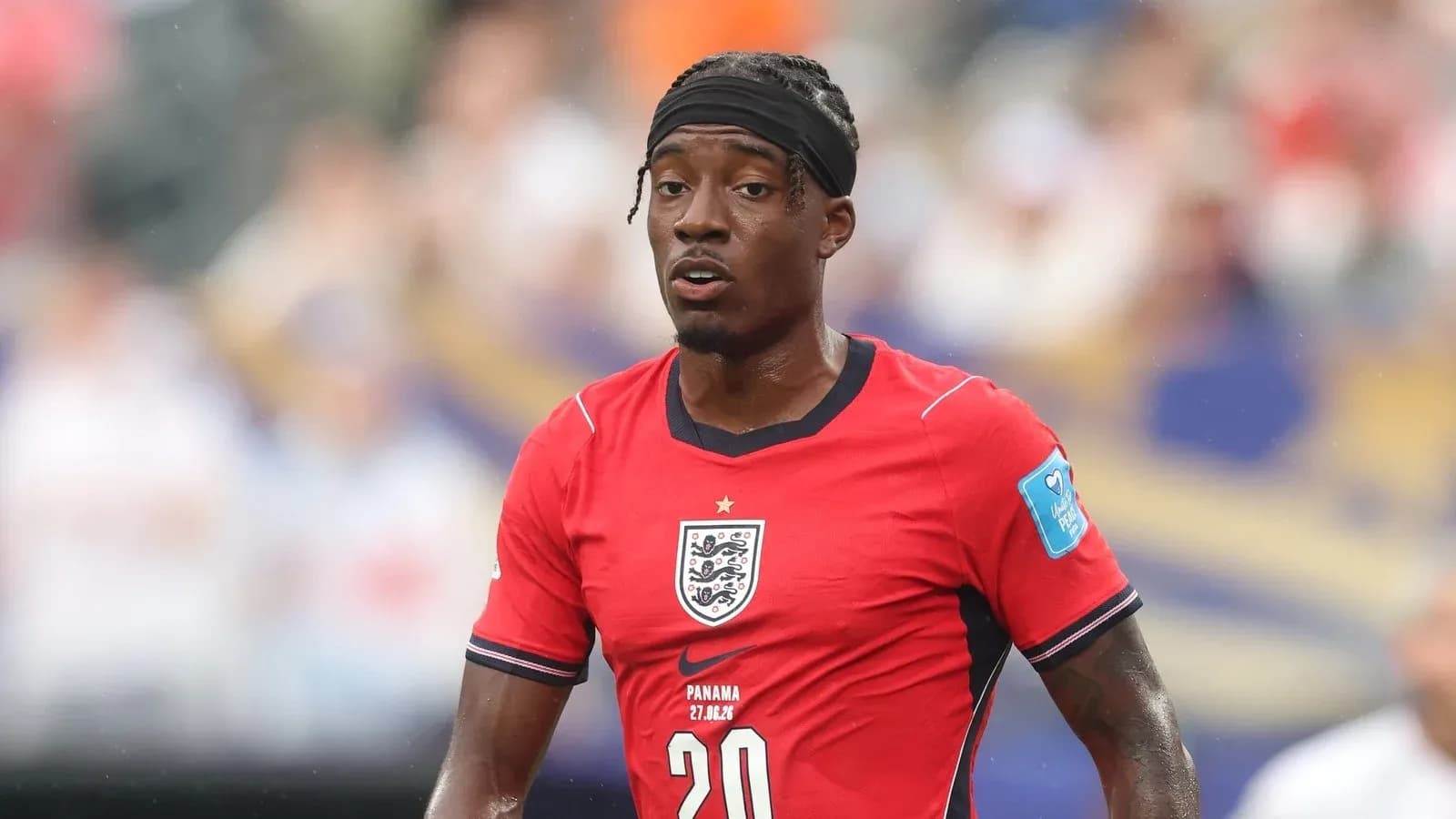 Player wearing red England jersey during match