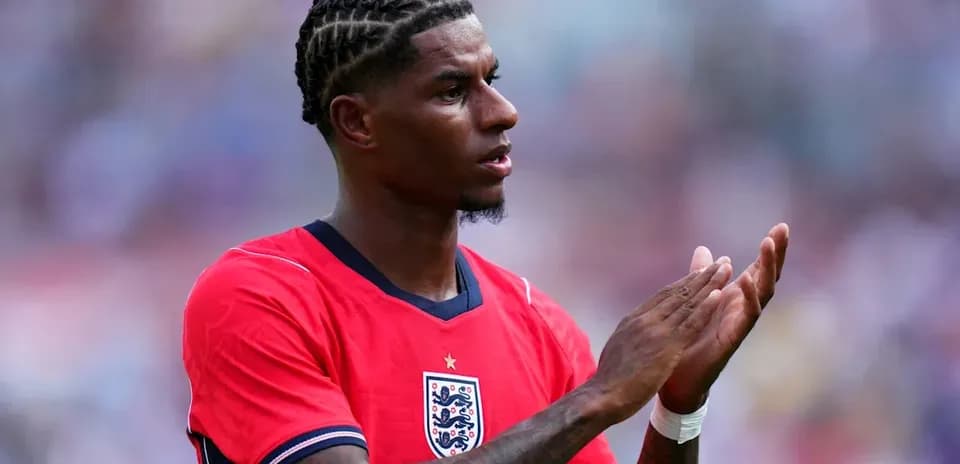 Player clapping in red England jersey during match