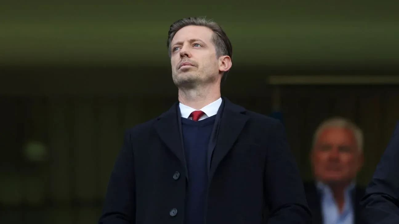 Man in suit observing from a stadium box