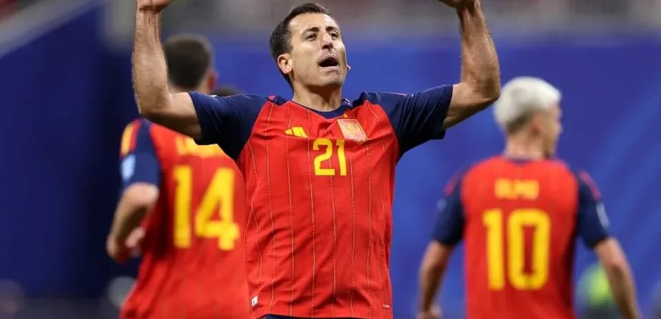 Player celebrating with teammates in Spain jersey