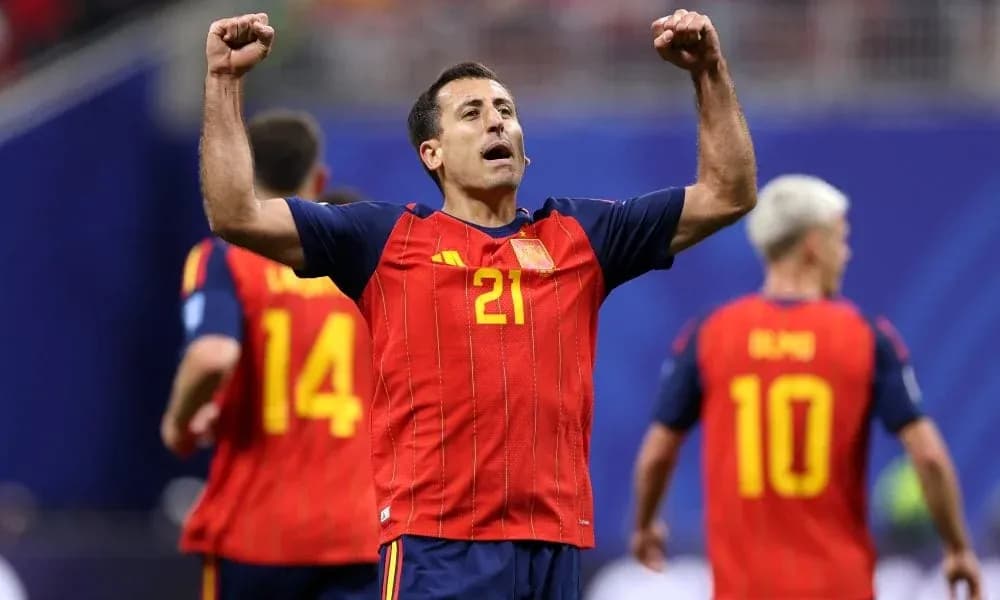 Player celebrating with teammates in Spain jersey