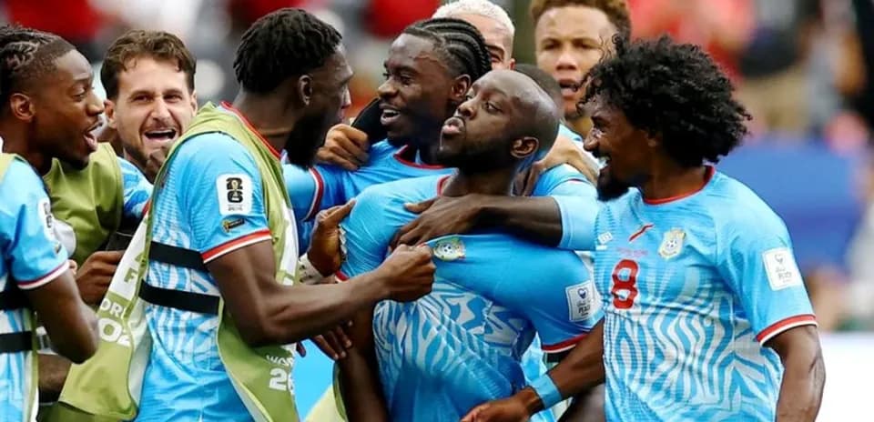 Players celebrating a goal on the field