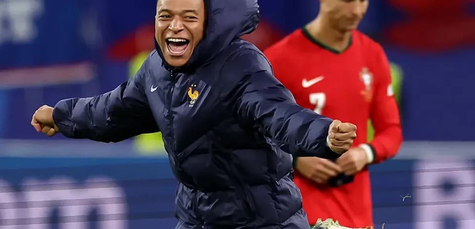 Kylian Mbappé celebrating in France jacket during match