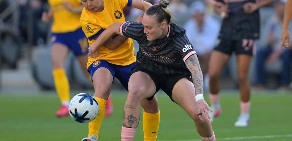 Players competing for the ball in NWSL match