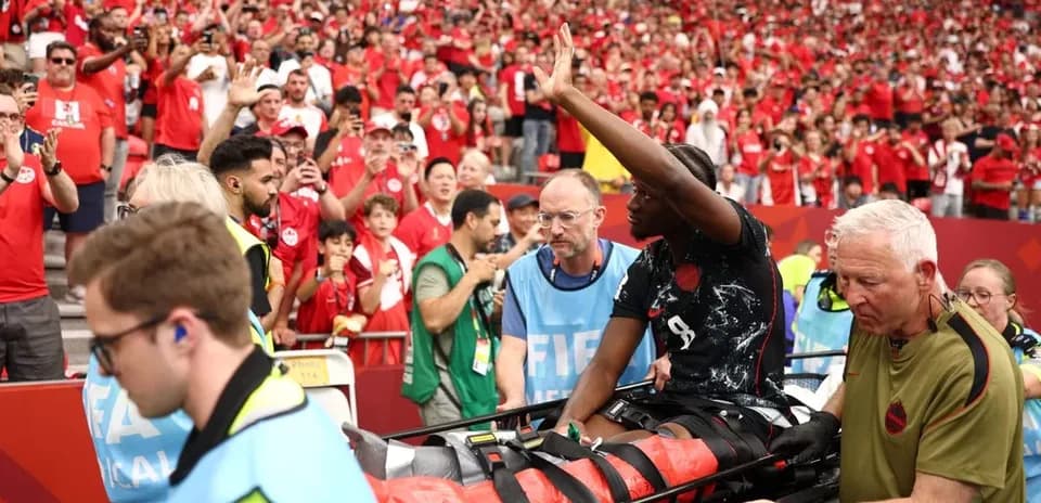 Player being taken off on stretcher with fans reacting