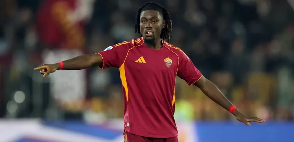 Player gesturing during match wearing Roma jersey