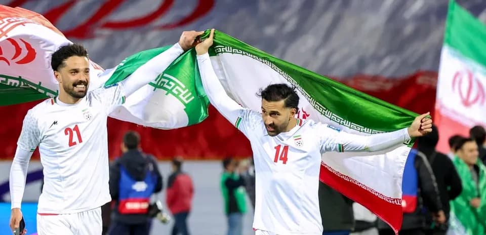 Iranian players celebrating with national flags