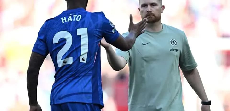 Player Hato shaking hands with team staff