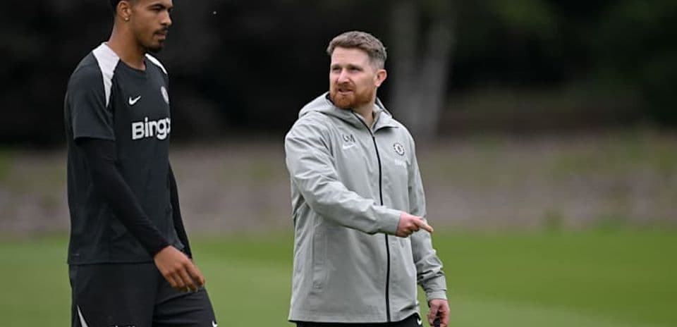 Player and coach walking during training session