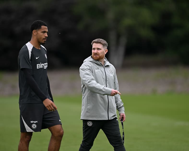 Player and coach walking during training session