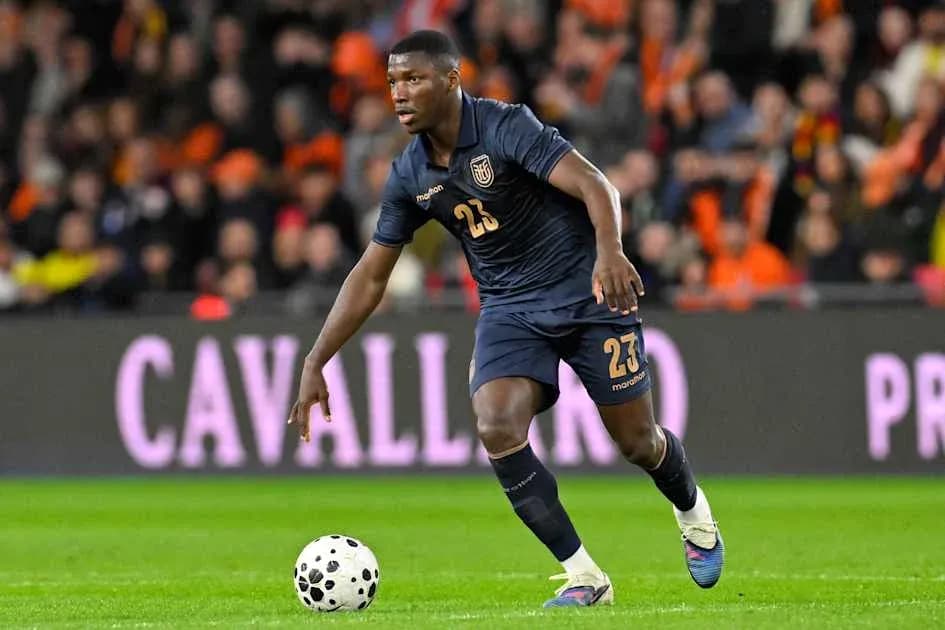 Player in dark jersey dribbling ball during match