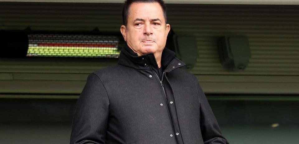 Man in black coat standing at stadium entrance