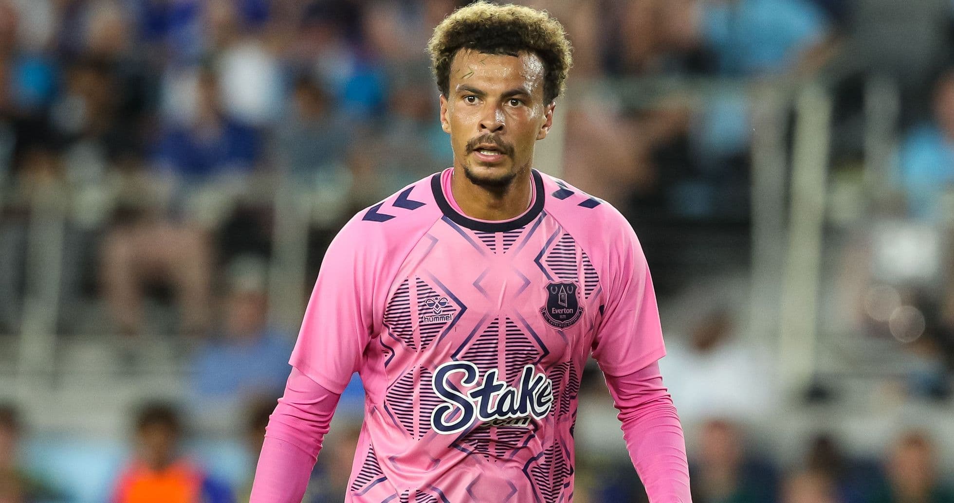 Goalkeeper wearing pink jersey during match action